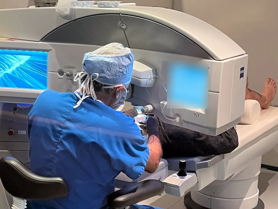 Dr. Khanna performing SMILE at the ZEISS VISUMAX laser, with the patient lying under the laser